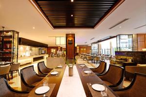a restaurant with wooden tables and chairs and a kitchen at SSAW Boutique Hotel Hangzhou Qiandao Lake in Chun'an
