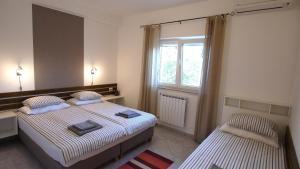 a bedroom with two beds and a window at Paklenica Sport Apartments in Starigrad