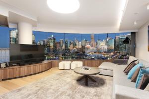 a living room with a view of a city at 3 Bedroom Darling Harbour Apartment in Sydney