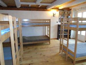 a room with three bunk beds in a house at La Bastide St Paul in Anglès