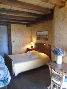 ein Schlafzimmer mit einem großen Bett und einem Tisch in der Unterkunft La Bastide St Paul in Anglès