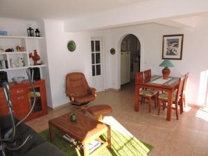 a living room with a table and a chair at Nerja Villas-Capistrano in Nerja