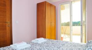 a bedroom with a bed with two towels on it at Apartmani Bulajic in Tivat +51 photos
