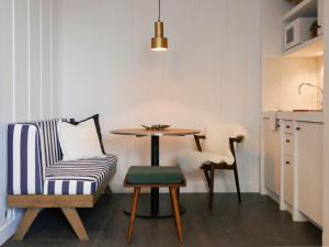 a living room with a table and a chair at Getaway Oostende in Ostend