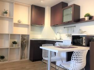 a kitchen with a white table and chairs at Sky Apartments in Blagoevgrad