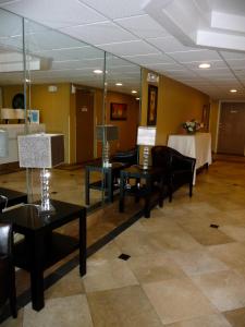 a waiting room with tables and chairs and a mirror at Gulfview Hotel - On the Beach in Clearwater Beach