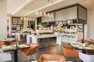A restaurant or other place to eat at Centro Waha by Rotana