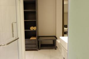 a bathroom with a sink and a cabinet with towels at Maehaad Bay Resort - SHA Plus in Mae Haad