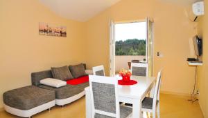 a living room with a couch and a table at Apartmani Bulajic in Tivat