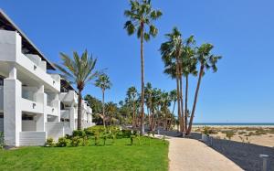a building on the beach with palm trees at INNSiDE by Meliá Fuerteventura – Adults Only in Costa Calma
