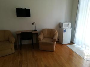 a living room with a couch, coffee table and a television at Capital Guesthouse Budapest in Budapest