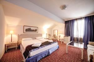 a hotel room with two beds and a couch at Visconti Militari in Bucharest +91 photos