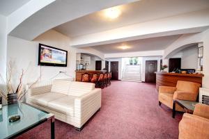 a living room with a couch and a table at Visconti Militari in Bucharest