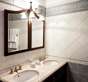 a bathroom with two sinks and a mirror at Villa Stefano in Dicomano