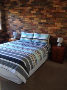 A bed or beds in a room at Unit 2 @ Beach Haven