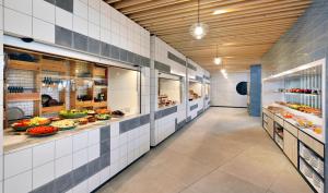 a kitchen with lots of food on display at INNSiDE by Meliá Fuerteventura – Adults Only in Costa Calma