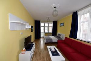 a living room with a red couch and a bed at Brilliant location 1 in Ulaanbaatar