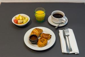 a table with a plate of food and a cup of coffee at Thalacap Île de Ré - Thalasso & Spa in Ars-en-Ré