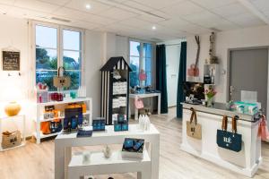 a store with two tables in a room at Thalacap Île de Ré - Thalasso & Spa in Ars-en-Ré