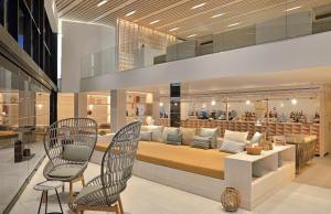 a living room with a couch and two chairs at INNSiDE by Meliá Fuerteventura – Adults Only in Costa Calma