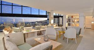 a living room with chairs and a bar with a view at INNSiDE by Meliá Fuerteventura – Adults Only in Costa Calma