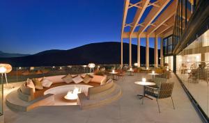 a patio with a couch and tables and chairs at INNSiDE by Meliá Fuerteventura – Adults Only in Costa Calma