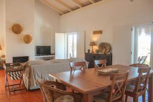 a living room with a table and a couch at Comporta House in Comporta
