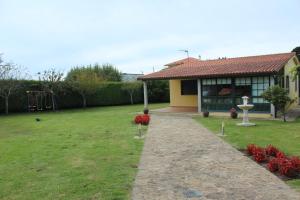 a house with a playground in a yard at Chalet privado playa de Boa in Noya