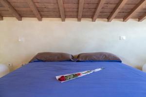 a blue bed with a tray of flowers on it at The Artist's Loft in Lucca