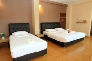 מיטה או מיטות בחדר ב-Triple Trees Hotel