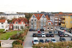 a city with cars parked in a parking lot at Hotel Noordzee in Domburg