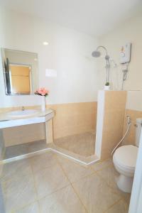 a bathroom with a sink and a toilet at Triple Trees Hotel in Pathum Thani
