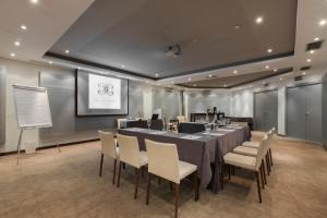a conference room with a long table and chairs at The Excelsior - Small Luxury Hotels of the World in Thessaloniki