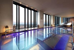 una piscina en un hotel con grandes ventanas en Eurostars Madrid Tower, en Madrid