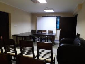 a conference room with a table and chairs and a screen at Hotel Sveti Nikola in Sliven