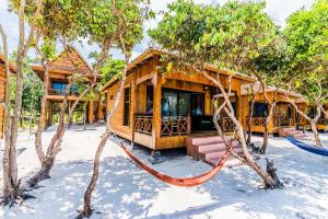 a resort cabin with a hammock in the snow at Sol Beach Resort in Koh Rong Sanloem