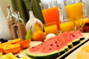 a table topped with a plate of fruit and juice at Boutique Hotel Bol in Bol