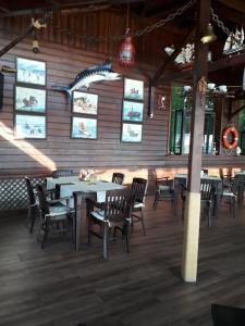 a dining room with tables and chairs and windows at Hotel Sveti Nikola in Sliven +18 photos