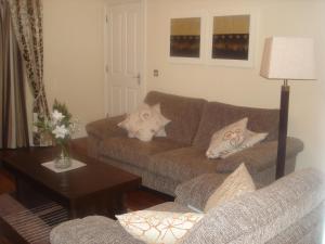 a living room with a couch and a table at No 33 Ardmullen in Kenmare