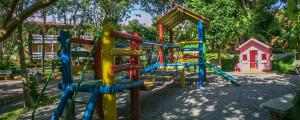 a playground with a colorful playground at Hotel São Sebastião da Praia in Florianópolis