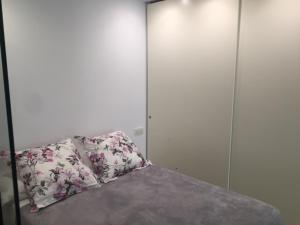 a bedroom with a bed with a pillow on it at Dream Canteras in Las Palmas de Gran Canaria