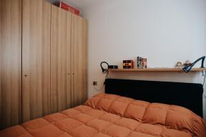 a bedroom with a bed and a wooden cabinet at Val di Luce - Interno 19 in Abetone