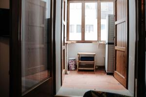an open door of a room with a hallway with a room with a window at Val di Luce - Interno 19 in Abetone
