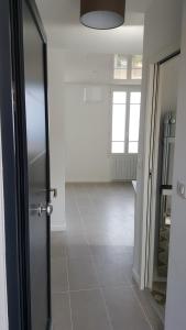 an empty room with a door and a tile floor at Maison / Appart Le PIOL in Nice