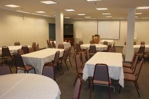 a classroom with white tables and chairs and a whiteboard at Ranch Inn Jackson Hole in Jackson