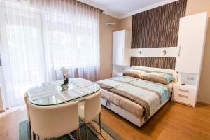 Posteľ alebo postele v izbe v ubytovaní Lara Apartments