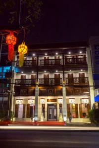 a building at night with a street in front of it at Villa Lantara Chiangmai in Chiang Mai