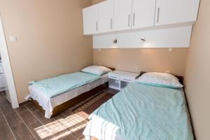 Posteľ alebo postele v izbe v ubytovaní Lara Apartments