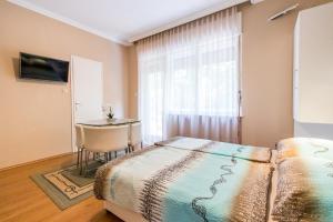 Posteľ alebo postele v izbe v ubytovaní Lara Apartments