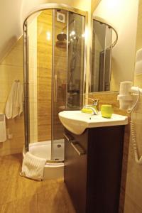 a bathroom with a shower and a sink and a shower at Kościelisko Residence Apartament HALSZKA 29C in Kościelisko